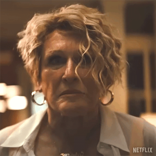 A Close Up Of A Woman 'S Face With A Netflix Logo On The Bottom GIF