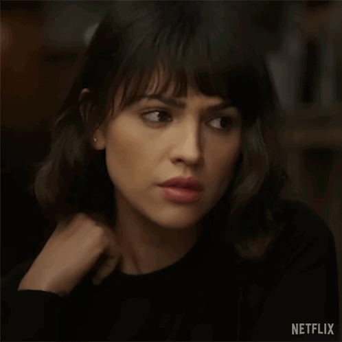 A Close Up Of A Woman 'S Face With A Netflix Logo On The Bottom Right . GIF