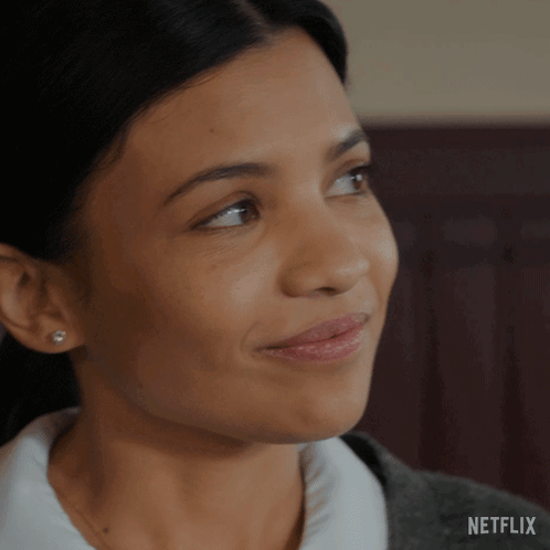 A Close Up Of A Woman 'S Face With A Netflix Logo On The Bottom GIF
