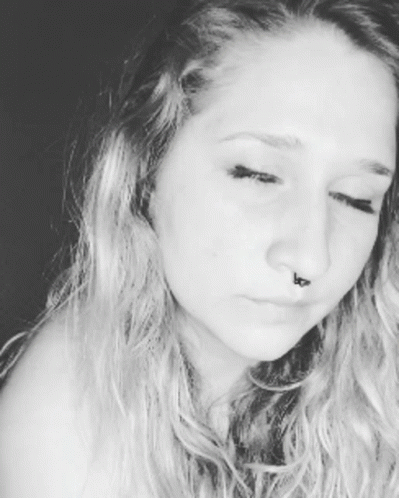 A Close Up Of A Woman 'S Face With A Nose Ring GIF