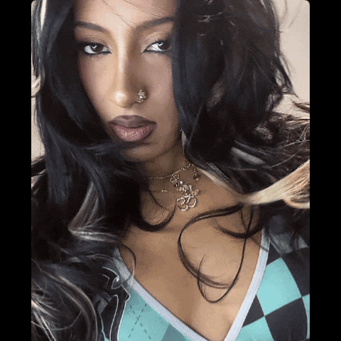 A Close Up Of A Woman 'S Face With A Nose Ring And Necklace GIF