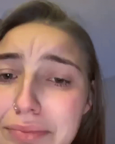 A Close Up Of A Woman 'S Face With A Nose Ring On It . GIF