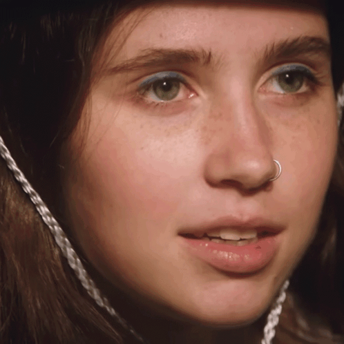 A Close Up Of A Woman 'S Face With A Nose Ring On It GIF