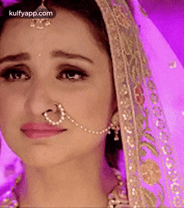 A Close Up Of A Woman 'S Face With A Nose Ring . GIF