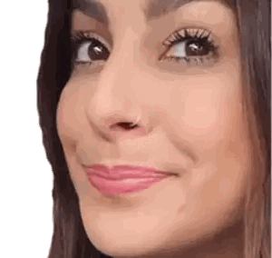 a close up of a woman 's face with a piercing in her nose