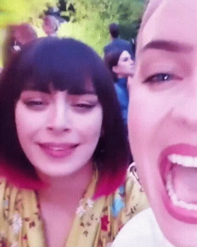 A Close Up Of A Woman 'S Face With A Pink Background GIF