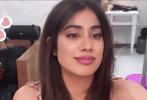A Close Up Of A Woman 'S Face With A Pink Lip Gloss On Her Lips . GIF