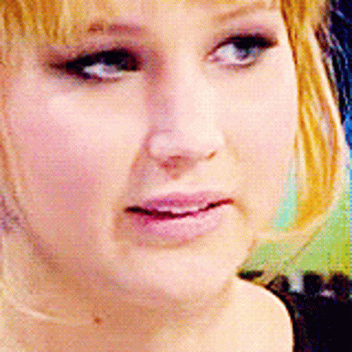 A Close Up Of A Woman 'S Face With A Pink Lip GIF