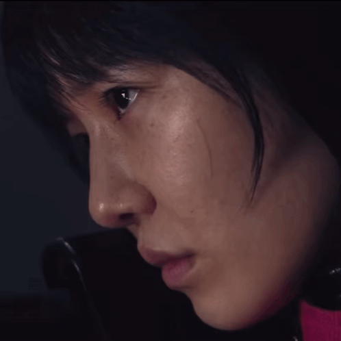 A Close Up Of A Woman 'S Face With A Pink Shirt On GIF