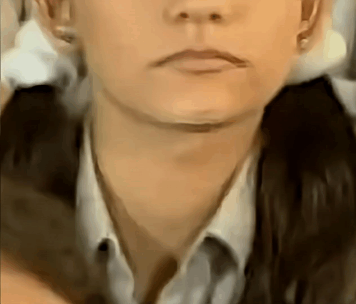 a close up of a woman 's face with a ponytail