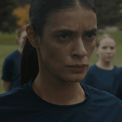 A Close Up Of A Woman 'S Face With A Ponytail GIF