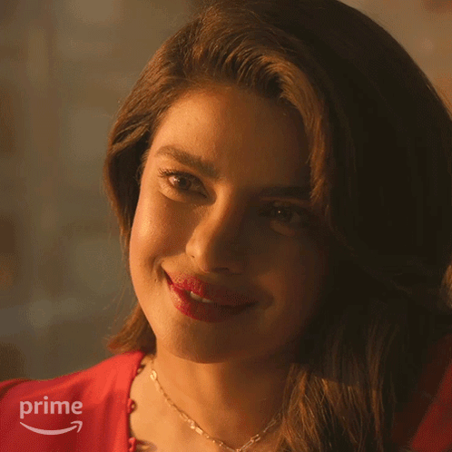 A Close Up Of A Woman 'S Face With A Prime Logo Behind Her GIF