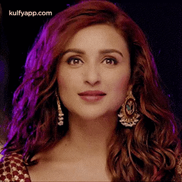 A Close Up Of A Woman 'S Face With A Purple Background . GIF