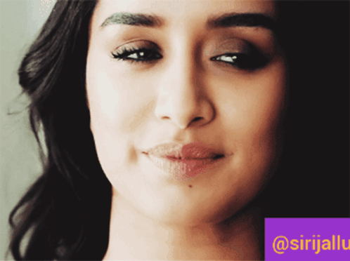 A Close Up Of A Woman 'S Face With A Purple Border That Says @Srijalu GIF
