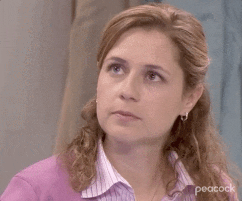 A Close Up Of A Woman 'S Face With A Purple Shirt On . GIF