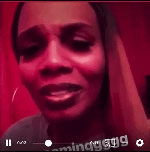 A Close Up Of A Woman 'S Face With A Red Background GIF