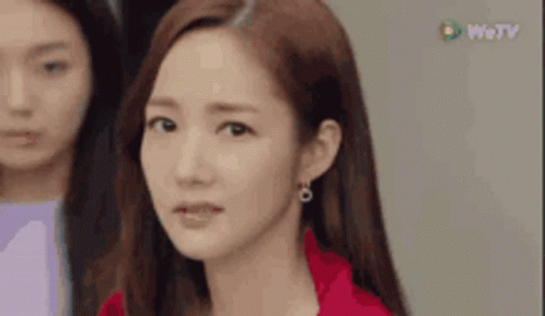 A Close Up Of A Woman 'S Face With A Red Jacket On . GIF