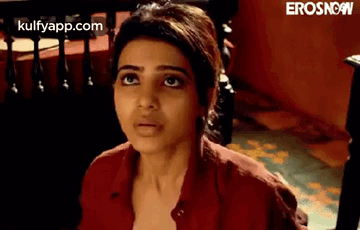 A Close Up Of A Woman 'S Face With A Red Shirt On . GIF