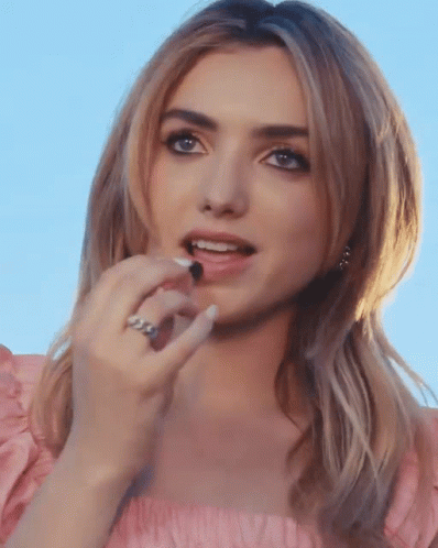 A Close Up Of A Woman 'S Face With A Ring On Her Left Hand GIF