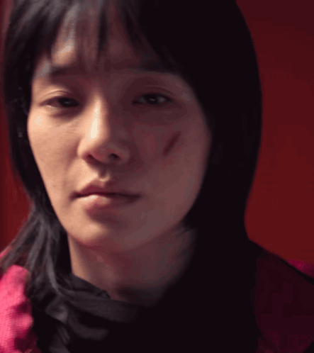 A Close Up Of A Woman 'S Face With A Scar On Her Face GIF