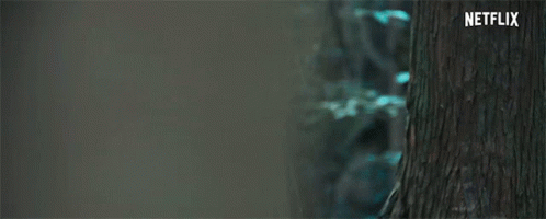 A Close Up Of A Woman 'S Face With A Scarf Around Her Neck And A Netflix Logo In The Corner . GIF