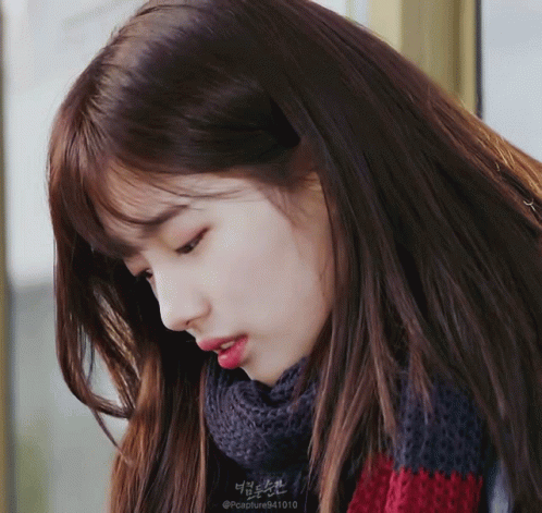 A Close Up Of A Woman 'S Face With A Scarf Around Her Neck That Says @Capture941010 GIF