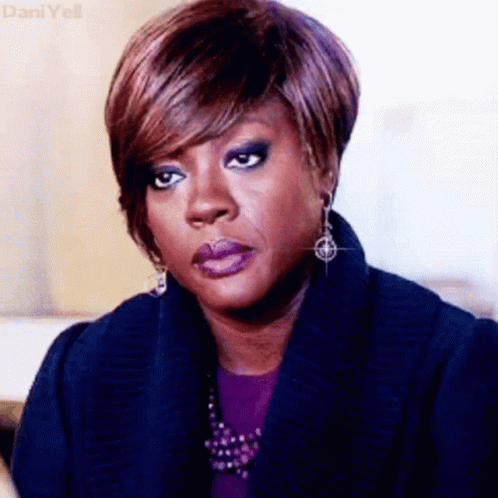A Close Up Of A Woman 'S Face With A Serious Look On Her Face GIF