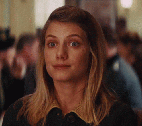 A Close Up Of A Woman 'S Face With A Serious Look On Her Face GIF