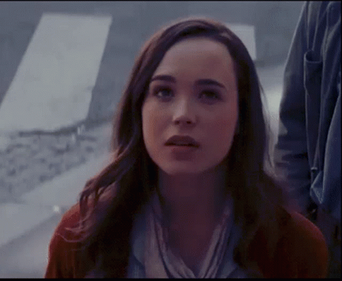 A Close Up Of A Woman 'S Face With A Serious Look On Her Face GIF