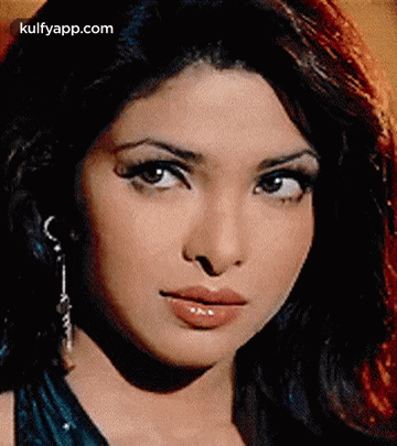 A Close Up Of A Woman 'S Face With A Serious Look On Her Face GIF