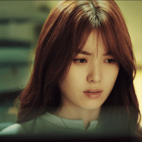 A Close Up Of A Woman 'S Face With A Serious Look On Her Face GIF