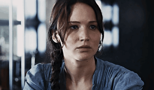 A Close Up Of A Woman 'S Face With A Serious Look On Her Face GIF