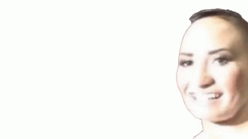A Close Up Of A Woman 'S Face With A Shaved Head . GIF