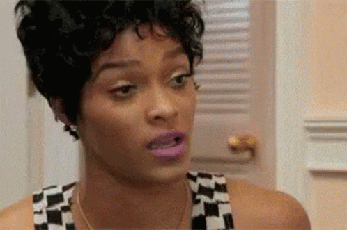 A Close Up Of A Woman 'S Face With A Shocked Look On Her Face . GIF