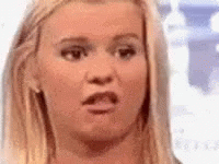 A Close Up Of A Woman 'S Face With A Shocked Look On Her Face . GIF