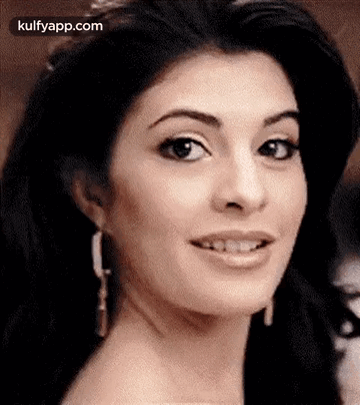 A Close Up Of A Woman 'S Face With A Slight Smile On Her Face . GIF