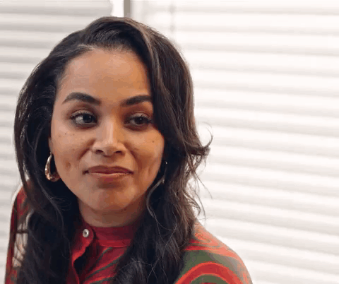 A Close Up Of A Woman 'S Face With A Slight Smile On Her Face . GIF