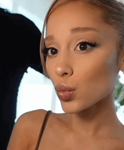 A Close Up Of A Woman 'S Face With A Slight Smile On Her Face GIF