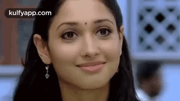A Close Up Of A Woman 'S Face With A Smile . GIF