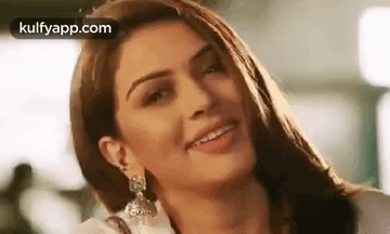 A Close Up Of A Woman 'S Face With A Smile On Her Face . GIF