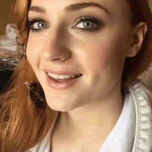 A Close Up Of A Woman 'S Face With A Smile On Her Face GIF