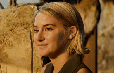 A Close Up Of A Woman 'S Face With A Smile On Her Face . GIF
