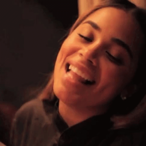A Close Up Of A Woman 'S Face With A Smile On Her Face GIF