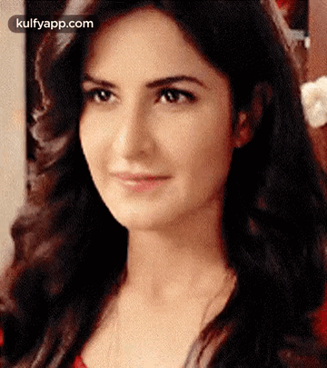 A Close Up Of A Woman 'S Face With A Smile On Her Face GIF