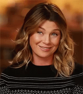 A Close Up Of A Woman 'S Face With A Smile On Her Face . GIF
