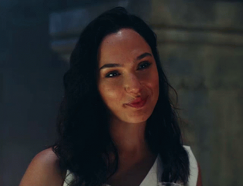 A Close Up Of A Woman 'S Face With A Smile On Her Face GIF