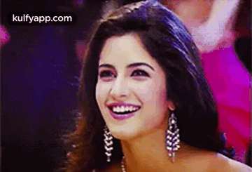 A Close Up Of A Woman 'S Face With A Smile On Her Face . GIF