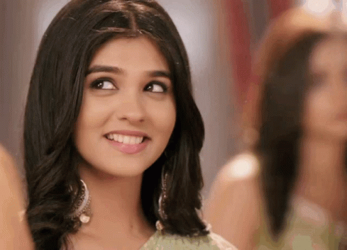 A Close Up Of A Woman 'S Face With A Smile On It GIF