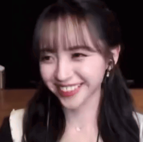 A Close Up Of A Woman 'S Face With A Smile On It . GIF