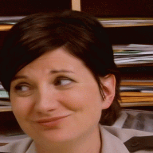 A Close Up Of A Woman 'S Face With A Smile GIF